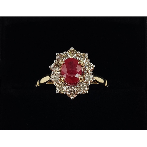 31 - A 9CT YELLOW GOLD RUBY AND DIAMOND RING, the mixed cut ruby of approximately 1 carat, surrounded by ... 