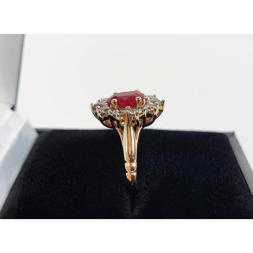 31 - A 9CT YELLOW GOLD RUBY AND DIAMOND RING, the mixed cut ruby of approximately 1 carat, surrounded by ... 