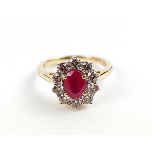 31 - A 9CT YELLOW GOLD RUBY AND DIAMOND RING, the mixed cut ruby of approximately 1 carat, surrounded by ... 