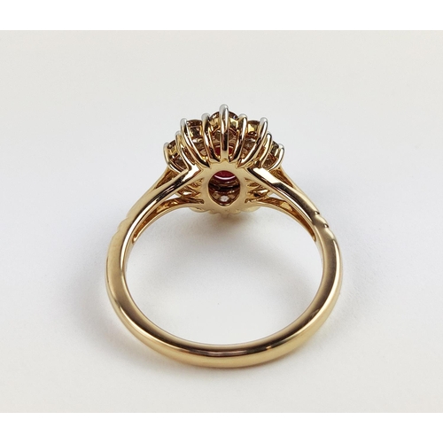 31 - A 9CT YELLOW GOLD RUBY AND DIAMOND RING, the mixed cut ruby of approximately 1 carat, surrounded by ... 