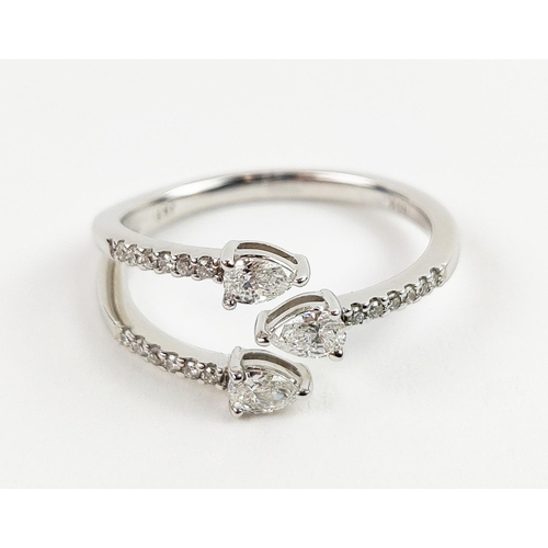 35 - A 9CT WHITE GOLD DIAMOND RING, with three main pear shaped diamonds, diamond set shoulders, total di... 