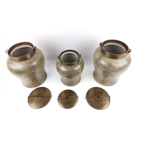 4 - THREE JARS AND COVERS, shagreen finish, to ceramic bodies, brass covers, inverted baluster form, 37c... 