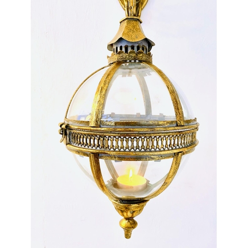 322 - WALL HANGING GLOBE LANTERNS, a pair, Regency style gilt metal and glass, 80cm H x 25cm W x 25cm D. (... 