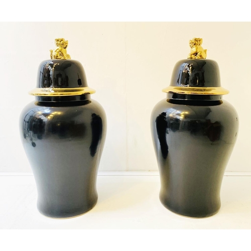 323 - TEMPLE JARS, a pair, Chinese style black and gold ceramic. (2)