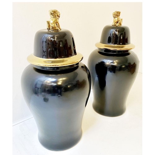 323 - TEMPLE JARS, a pair, Chinese style black and gold ceramic. (2)