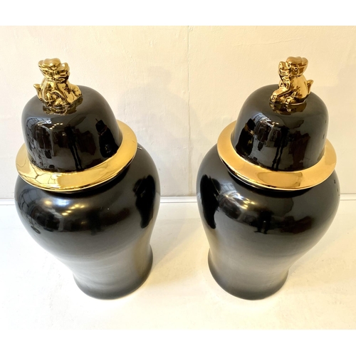 323 - TEMPLE JARS, a pair, Chinese style black and gold ceramic. (2)