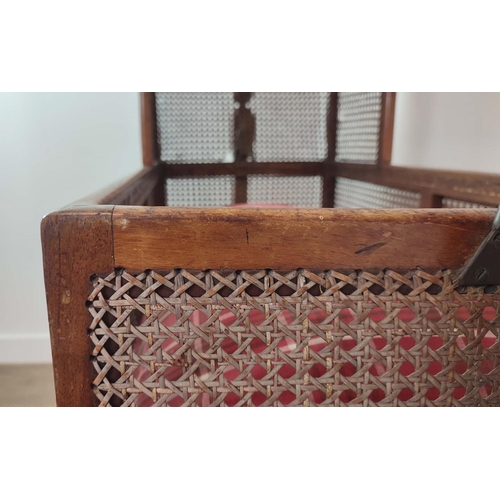 359 - CRADLE, George IV mahogany and caned with pine slatted base, check cushion and brass castors, 136cm ... 