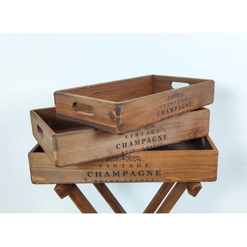 383 - WOODEN TRAYS ON STAND, graduated set of three trays, 80cm H x 56cm W x 38cm D.