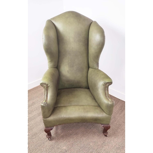 396 - WING ARMCHAIR, Victorian mahogany in green leather on steel castors, 132cm H x 79cm W x 95cm D.