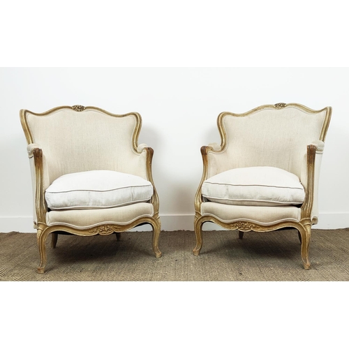 371 - BERGERE CHAIRS, a pair, with carved distressed painted showframes and linen upholstery, each 67cm W ... 