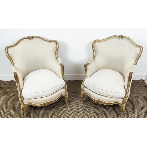 371 - BERGERE CHAIRS, a pair, with carved distressed painted showframes and linen upholstery, each 67cm W ... 