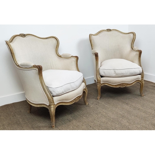 371 - BERGERE CHAIRS, a pair, with carved distressed painted showframes and linen upholstery, each 67cm W ... 