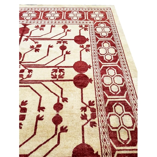 129 - FINE KHOTAN POMEGRANITE DESIGN CARPET, 318cm x 245cm.