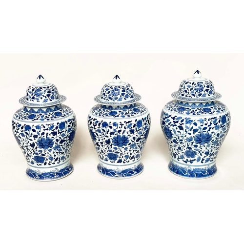 192 - TEMPLE JARS, a set of three, Chinese ceramic blue and white lotus leaf of ginger jar form with lids,... 