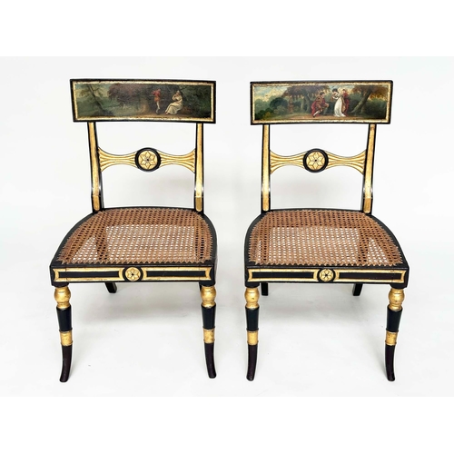 194 - REGENCY SIDE CHAIRS, a pair, ebonised and parcel gilt each with hand painted bow back rail and cane ... 