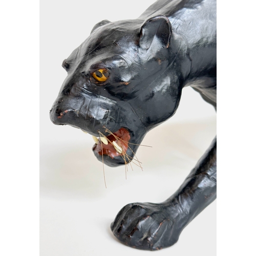 304 - LIBERTY STYLE PANTHER, in the manner of Liberty of London leather covered, 70cm W x 34cm H.