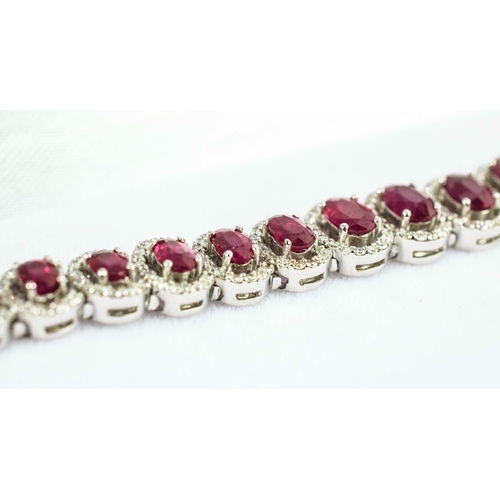 38 - AN 18CT WHITE GOLD RUBY AND DIAMOND BRACELET, the links of graduated size each set with a mixed cut ... 