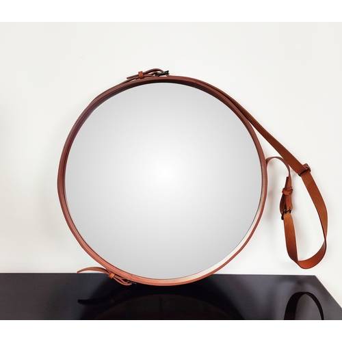 571 - GUBI ADNET HANGING MIRROR, circular with tan leather strapwork frame, 70cm W x 135cm H.