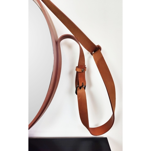 571 - GUBI ADNET HANGING MIRROR, circular with tan leather strapwork frame, 70cm W x 135cm H.