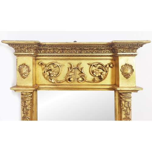 345 - AN EARLY 19TH CENTURY GILTWOOD WALL MIRROR, applied gesso decoration, 116cm H x 75cm W.