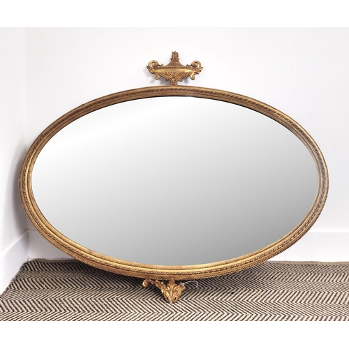 346 - A 19TH CENTURY GILTWOOD AND GESSO EDGED OVAL WALL MIRROR, bevelled glass, urn finial, 92cm H x 110cm... 