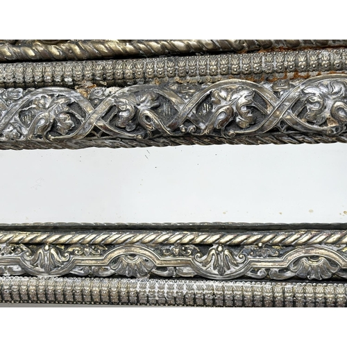 300 - WALL MIRROR, 19th century Dutch repousse silver and ebony rectangular bevelled with marginal plates ... 