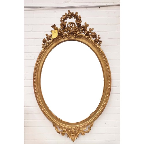 230 - OVAL WALL MIRROR, late 19th century French giltwood and gesso with bevelled plate and ornate floral ... 