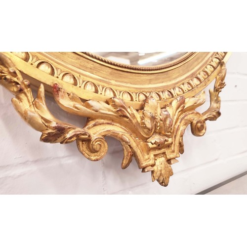 230 - OVAL WALL MIRROR, late 19th century French giltwood and gesso with bevelled plate and ornate floral ... 