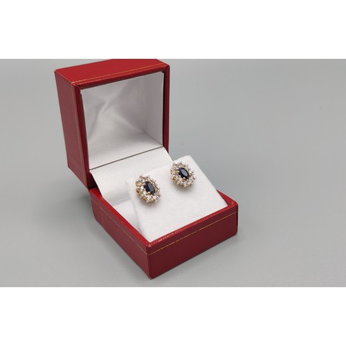 33 - A PAIR OF SAPPHIRE AND DIAMOND STUD EARRINGS, 9ct yellow gold backs, each with a single mixed cut sa... 