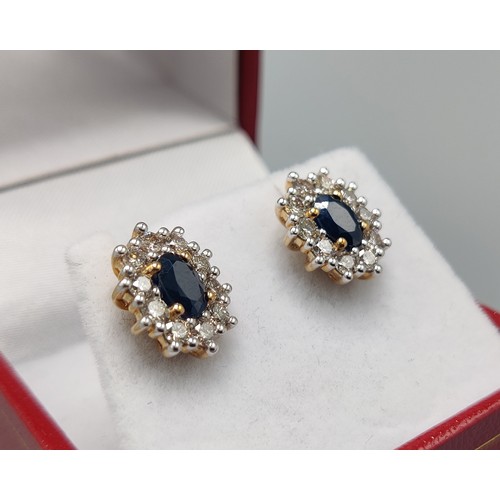 33 - A PAIR OF SAPPHIRE AND DIAMOND STUD EARRINGS, 9ct yellow gold backs, each with a single mixed cut sa... 