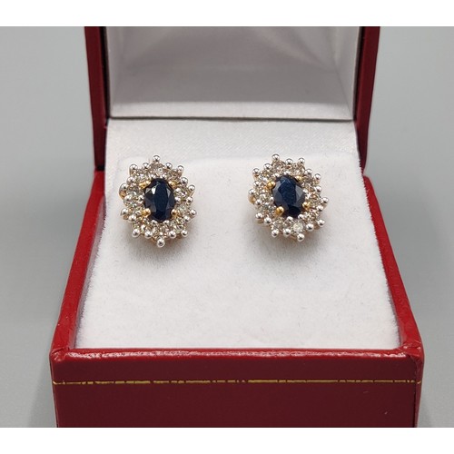 33 - A PAIR OF SAPPHIRE AND DIAMOND STUD EARRINGS, 9ct yellow gold backs, each with a single mixed cut sa... 