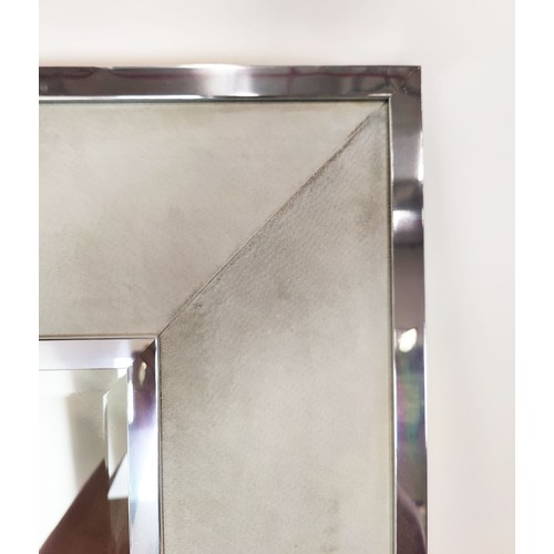 533 - WALL MIRROR, Alcantara upholstered frame, polished metal trim, bevelled plate, 227cm x 100cm.