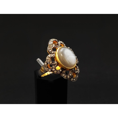 35 - A MOONSTONE AND DIAMOND COCKTAIL RING, the cabouchon moonstone of approximately 3.98 carats, surroun... 