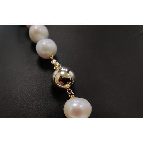 37 - A FRESHWATER WHITE PEARL SINGLE STRAND NECKLACE, fitted with 14mm oval pearls, on a 9ct yellow gold ... 