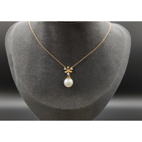 38 - A 9CT YELLOW GOLD CULTURED PEARL AND DIAMOND NECKLACE, icicle design, the pendant set with three dia... 