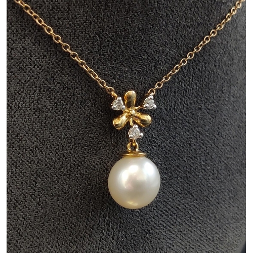 38 - A 9CT YELLOW GOLD CULTURED PEARL AND DIAMOND NECKLACE, icicle design, the pendant set with three dia... 