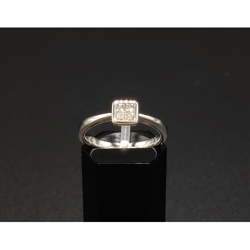 41 - A DIAMOND SET DRESS RING, 9ct white gold shank, set with four princess cut diamonds of approximately... 