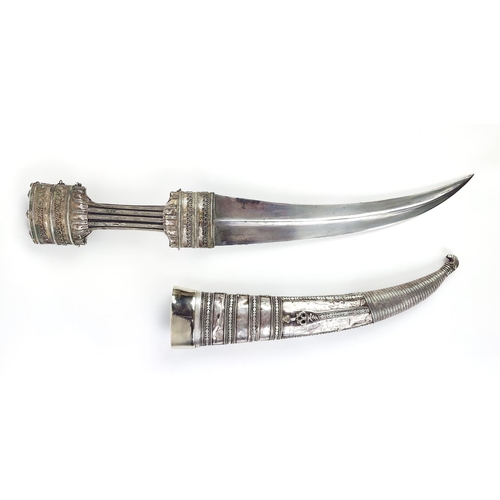 2 - A JAMBIYA DAGGER AND SCABBARD WHITE METAL CASING, steel blade, horn structure to scabbard, 52cm L