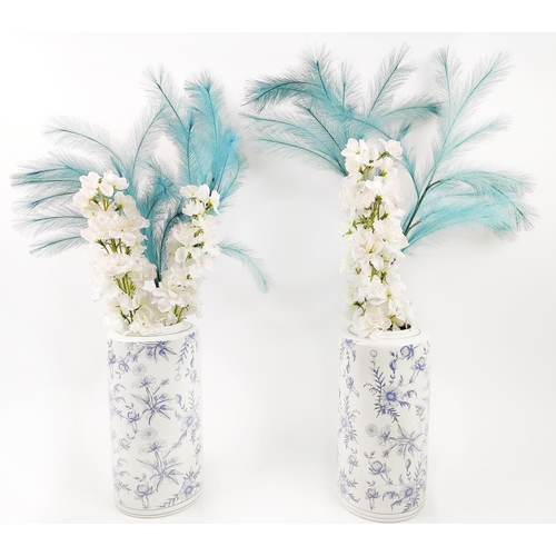 25 - A PAIR OF BLUE AND WHITE PORCELAIN VASES, with faux flowers, each vase 36cm H and 86cm H. (2)