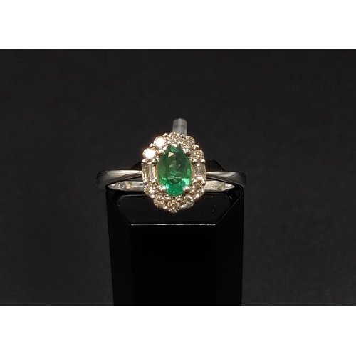 32 - AN 18CT WHITE GOLD EMERALD AND DIAMOND RING, the central oval cut emerald of approximately 0.45 cara... 