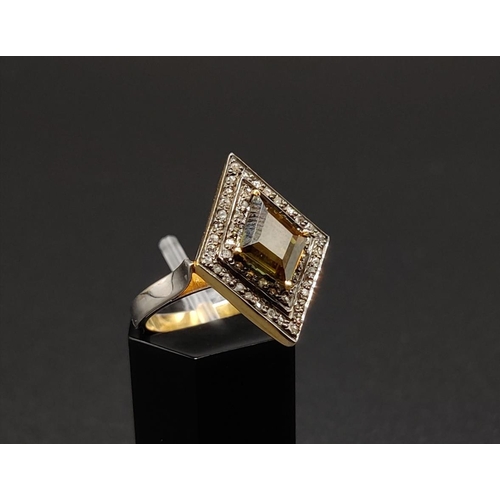 44 - A SILVER GILT KITE SHAPED DRESS RING set with a single tourmaline surrounded by a border of rose cut... 