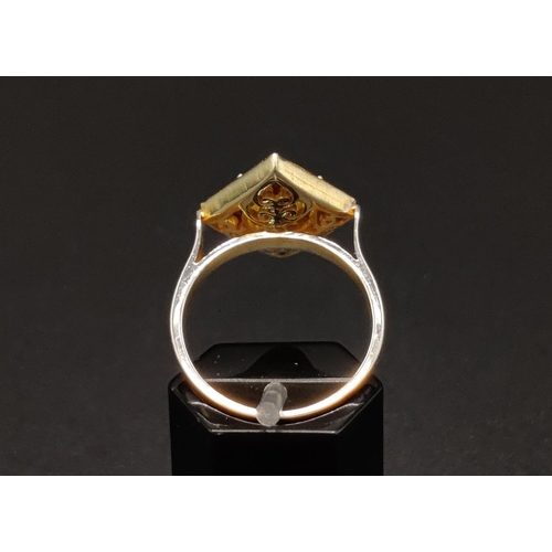 44 - A SILVER GILT KITE SHAPED DRESS RING set with a single tourmaline surrounded by a border of rose cut... 