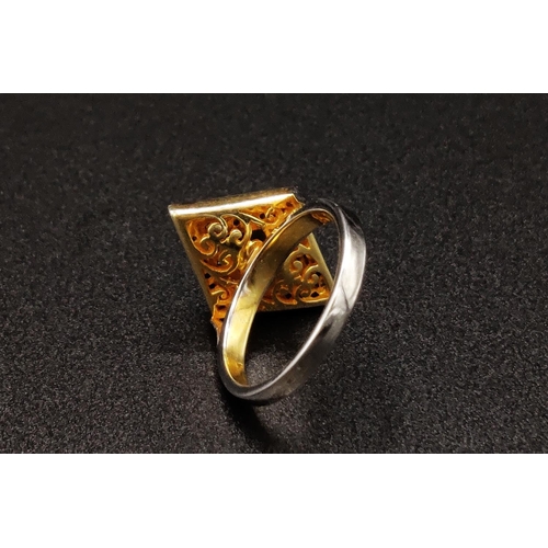 44 - A SILVER GILT KITE SHAPED DRESS RING set with a single tourmaline surrounded by a border of rose cut... 