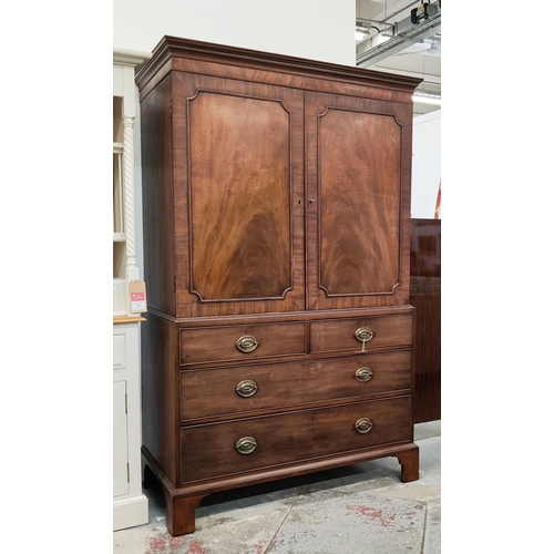 519 - AN EARLY 19TH CENTURY MAHOGANY LINEN PRESS, doors enclosing a fitted interior, drawers to base, brac... 