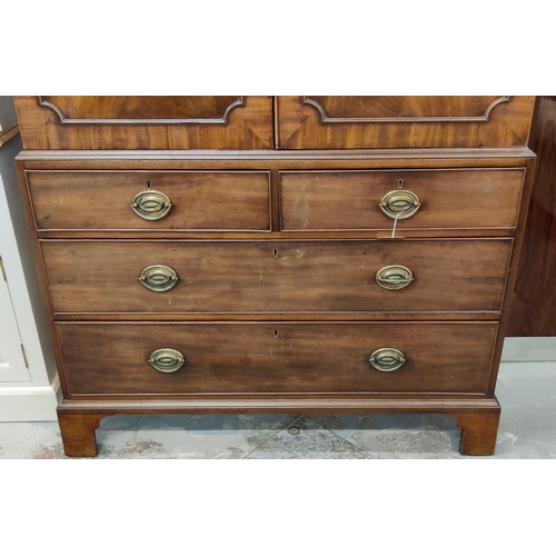 519 - AN EARLY 19TH CENTURY MAHOGANY LINEN PRESS, doors enclosing a fitted interior, drawers to base, brac... 