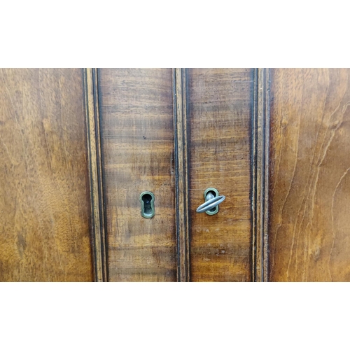 519 - AN EARLY 19TH CENTURY MAHOGANY LINEN PRESS, doors enclosing a fitted interior, drawers to base, brac... 