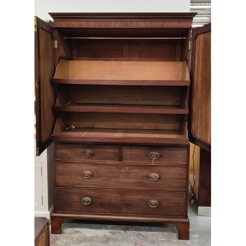 519 - AN EARLY 19TH CENTURY MAHOGANY LINEN PRESS, doors enclosing a fitted interior, drawers to base, brac... 