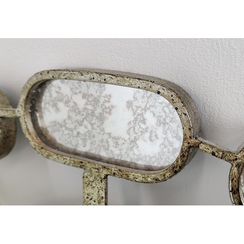 527 - OVAL WALL MIRROR, 122cm x 94cm, in a silvered metal frame with bevelled plate and a satellite border... 