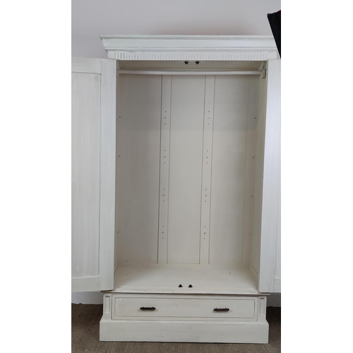 539 - OKA ARMOIRE, in a paint effect finish, with a pair of panelled doors, 126cm W x 61cm D x 215cm, encl... 