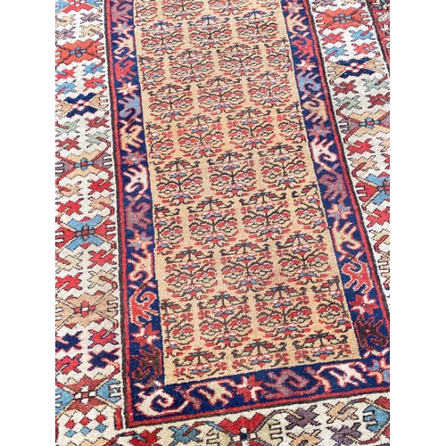 104 - ANTIQUE NORTH WEST PERSIAN SERAPI RUNNER, 400cm x 100cm.